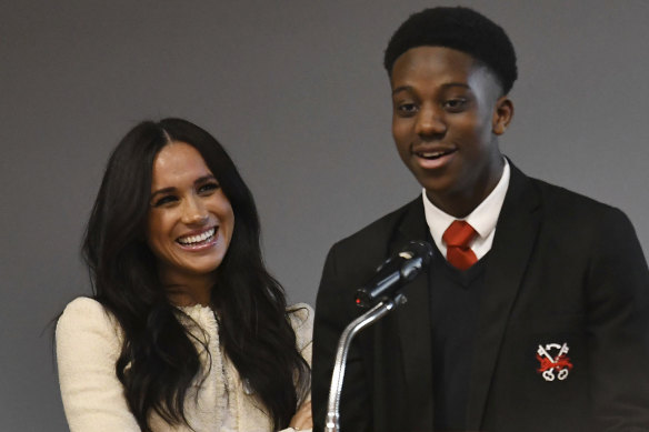 Meghan, Duchess of Sussex, smiles as head boy Aker Okoye speaks during her surprise visit to the Robert Clack Upper School in Dagenham, in east London, to celebrate International Women's Day.