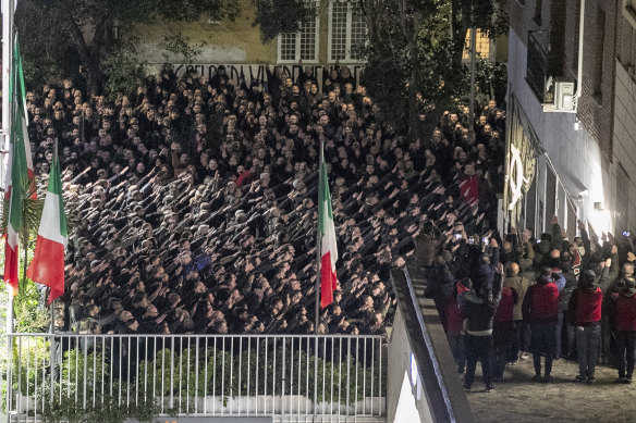 People appear to give the banned fascist salute during a rally in Rome, on Sunday to commemorate the slaying in 1978 of two members of a neo-fascist youth group in an attack later claimed by extreme-left militants.