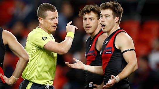 Lost in translation: Essendon's Zach Merrett (right) appeals to the umpire after the controversial call made during their round 9 match against the Lions.
