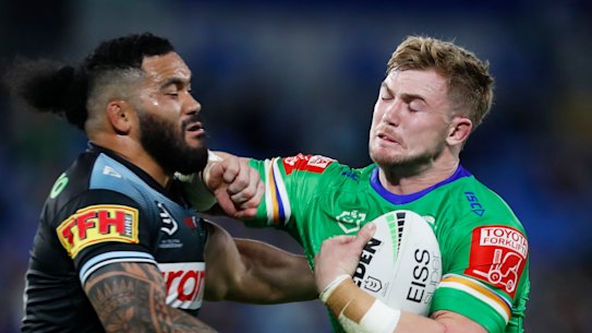 Raiders forward Hudson Young attempts to fend off Cronulla’s Siosifa Talakai.