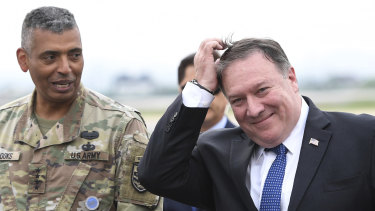US Secretary of State Mike Pompeo, right, walks with US General Vincent K. Brooks, left, commander of United States Forces Korea upon his arrival at Osan Air Base in Pyeongtaek.