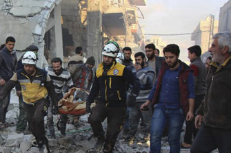 The Syrian Civil Defence rescue group, known as the White Helmets, evacuate the wounded after air strikes in the village of Balyoun.