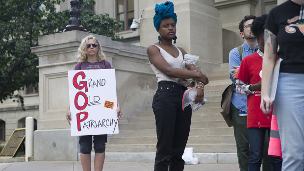 Protesters rally outside the Georgia Capitol building after the signing of the heartbeat abortion law.
