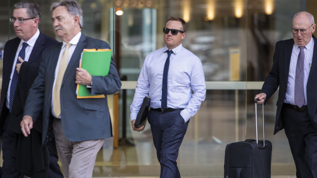 Shane Robert Graham (centre) is seen leaving the Brisbane District Court in Brisbane on Monday.