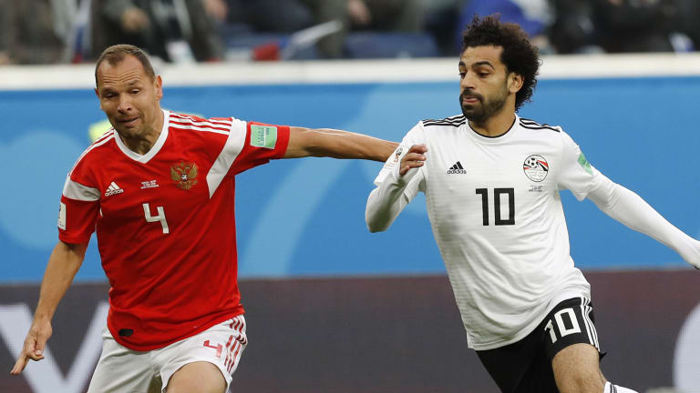 Seeking answers: Mohamed Salah (right) in action for Egypt during the World Cup.