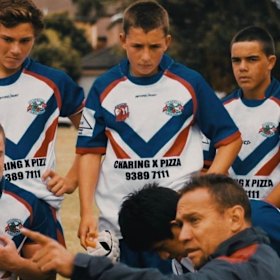 Victor Radley (middle) receives his orders from Clovelly Crocodiles coach Adrian Lam.