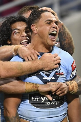 Latrell Mitchell celebrates his first try in a stirring comeback for NSW.