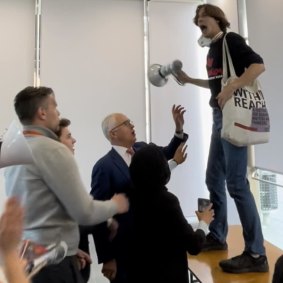 Deaglan Godwin protests against Malcolm Turnbull at a Sydney University Law Society event in September 2022.