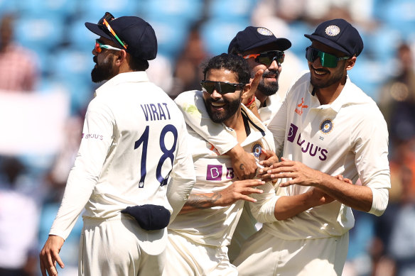 Ravindra Jadeja celebrates a wicket with his teammates.