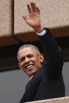 Barack Obama, waves to people at the Sydney Opera House on Friday.