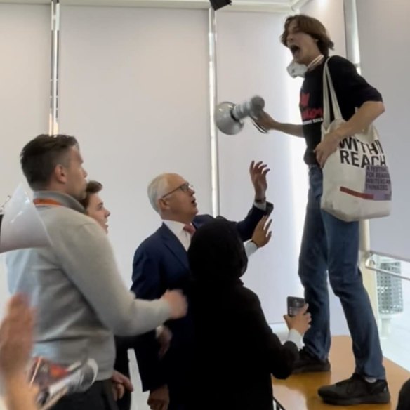 Deaglan Godwin protests against Malcolm Turnbull at a Sydney University Law Society event in September 2022.