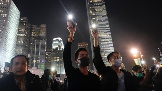 Protesters hold up their smartphone lights during a rally by education workers in Hong Kong, on Friday  January 3.