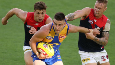 Make or break: West Coast's Elliot Yeo fends off a tackle from Melbourne's James Harmes.
