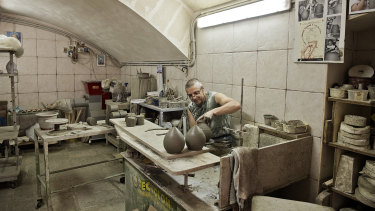 A ceramics maker at work in Enza Fasano, a ceramics shop in Grottaglie.