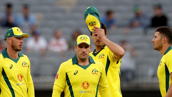 Long walk: The Australians leave the field after the heavy defeat in Perth.