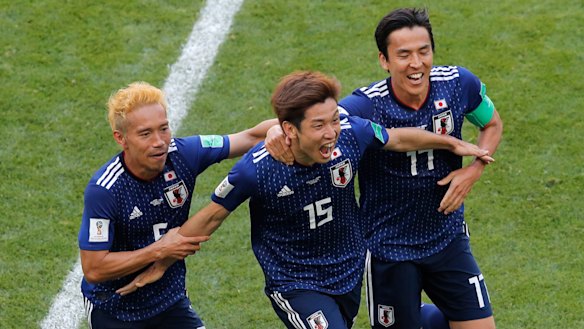 Big win: Yuya Osako, centre, celebrates with Yuta Nagatomo, left, and Makoto Hasebe after his goal.