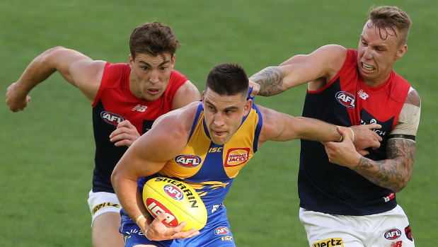Make or break: West Coast's Elliot Yeo fends off a tackle from Melbourne's James Harmes.