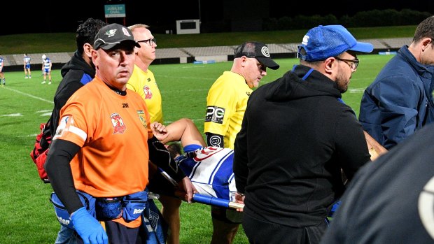 Down and out: Fine is carried off after suffering a serious injury late in the season.