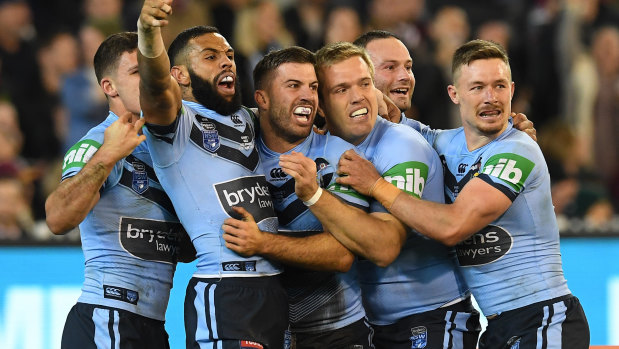 Positives: NSW celebrate James Tedesco's try at the MCG.