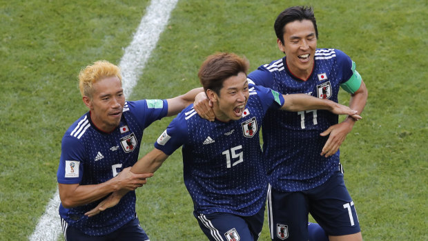 Big win: Yuya Osako, centre, celebrates with Yuta Nagatomo, left, and Makoto Hasebe after his goal.