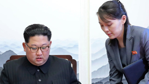 North Korean leader Kim Jong-un signs a guestbook next to his sister Kim Yo Jong, right, inside the Peace House at the border village of Panmunjom in Demilitarized Zone in 2018.