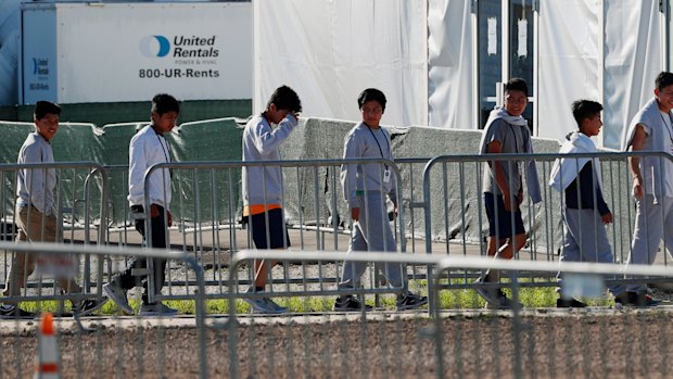 Children line up to enter a tent at the Homestead Temporary Shelter for Unaccompanied Children in Homestead, Florida. 