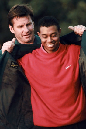 Nick Faldo presents Tiger Woods with his first green jacket in 1997.