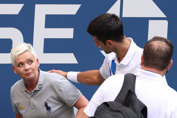 Djokovic continues to tend to the judge after she returned to her feet.