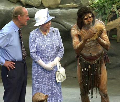 Prince Philip and the Queen in Cairns in 2002 watch as Warren Clements of the Tjapakai dance group makes fire.