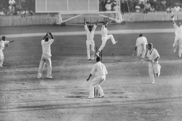 A tie! The first tie in 83 years of Test cricket. The First Test at the Brisbane Cricket Ground in December, 1960. Australia’s Ian Meckiff is run out as West Indian Joe Solomon (extreme left) hurls the ball and breaks the wicket. 