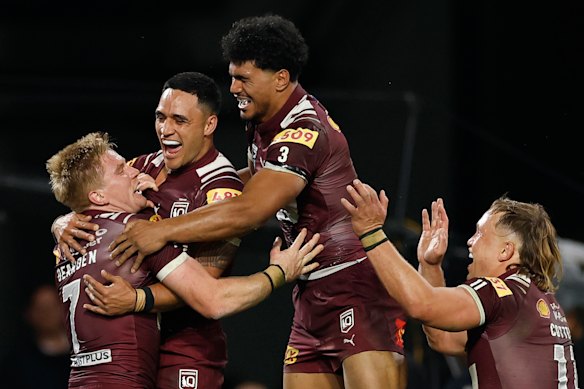 Tom Dearden celebrates with teammates after scoring.