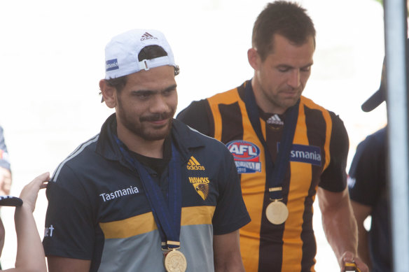 Cyril Rioli and Luke Hodge after the 2015 premiership win.