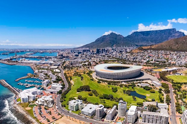 Cape Town V & A Waterfront harbour, Table Mountain and the DHL Stadium with the city centre seen from the sea and showing Green Point.
