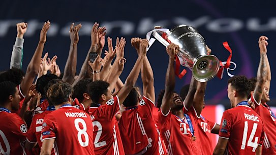 Coman lifts the Champions League trophy with his Bayern teammates.