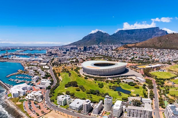 Cape Town V & A Waterfront harbour, Table Mountain and the DHL Stadium with the city centre seen from the sea and showing Green Point.