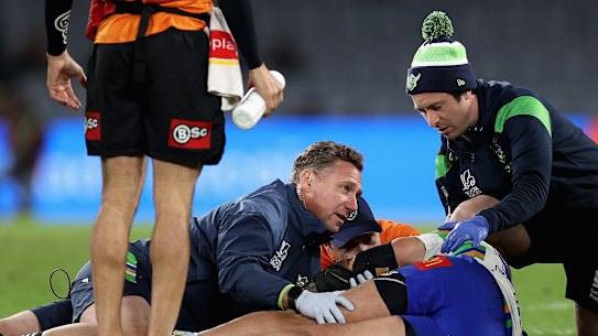 Raiders forward Corey Harawira-Naera receives attention after collapsing on the field.