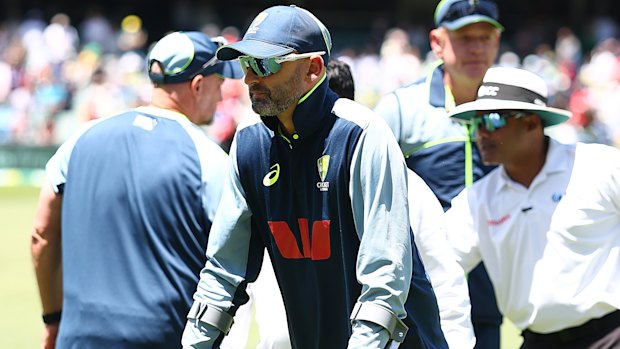 Nathan Lyon returned to the ground on crutches after suffering an apparent hamstring injury.