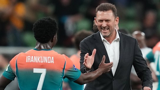 Nestory Irankunda with Australia’s coach Tony Popovic.