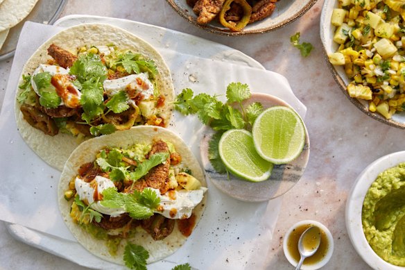 Hands-on feasting: Pork fajitas with pineapple and corn salsa, guacamole and sour cream.
