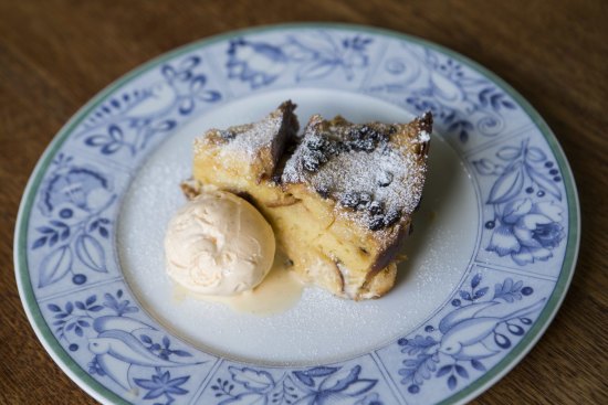 Dessert bread and butter pudding with vanilla ice cream.