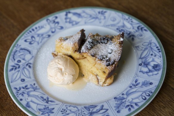 Dessert bread and butter pudding with vanilla ice cream.