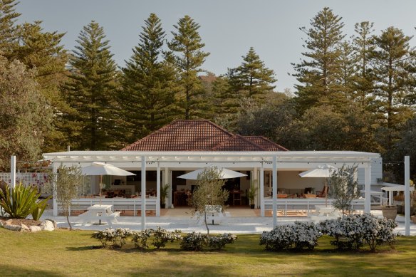 Whitewashed picnic tables and a grassy lawn at Dunes in Palm Beach.