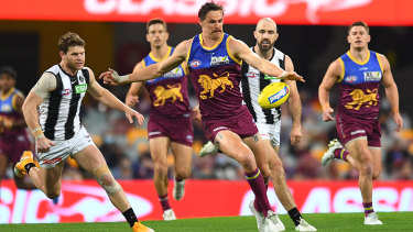 Joe Daniher gets a kick away for the Brisbane Lions against Collingwood at the Gabba in round 22.
