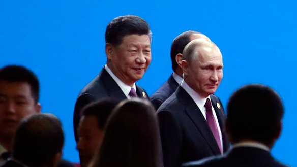 Xi Jinping and Russian President Vladimir Putin arrive for the opening ceremony of the second Belt and Road Forum for International Co-operation in Beijing on Friday.