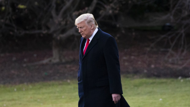 US President Donald Trump walks on the South Lawn of the White House before departing.