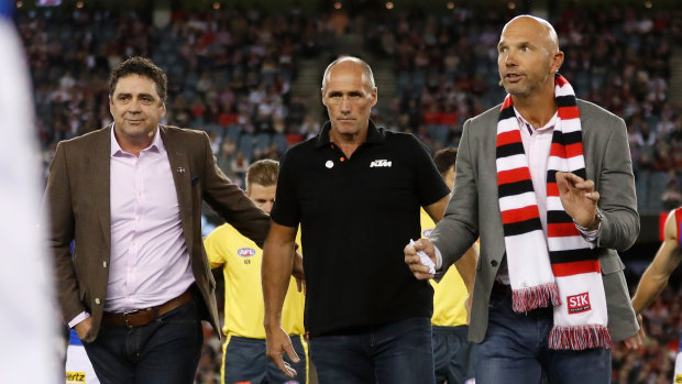 Garry Lyon, Tony Lockett and Stewart Loewe pause to remember Danny Frawley.