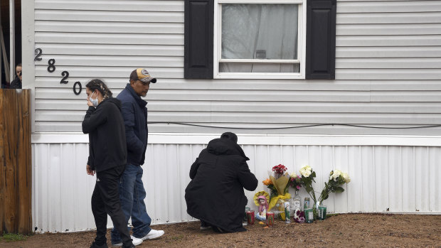 Mourners organize a memorial outside a mobile home in Colorado Springs, Colorado.