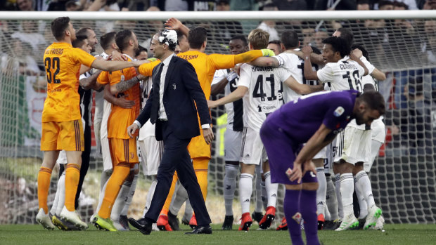 Juventus players celebrate their win over Fiorentina and clinching the title.