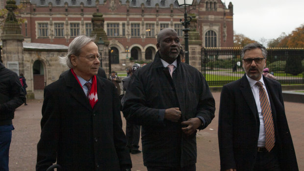 The Gambia's delegation with Justice Minister Aboubacarr Tambadou, centre, leaves the Peace Palace which houses the International Court in The Hague, Netherlands.