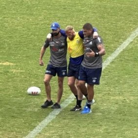 Luke Thompson leaves the field injured at Bulldogs training.